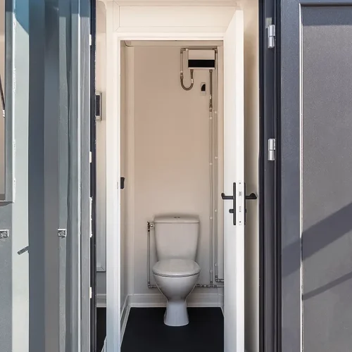 Sanitaire intégré dans un container maritime aménagé avec WC et équipements techniques